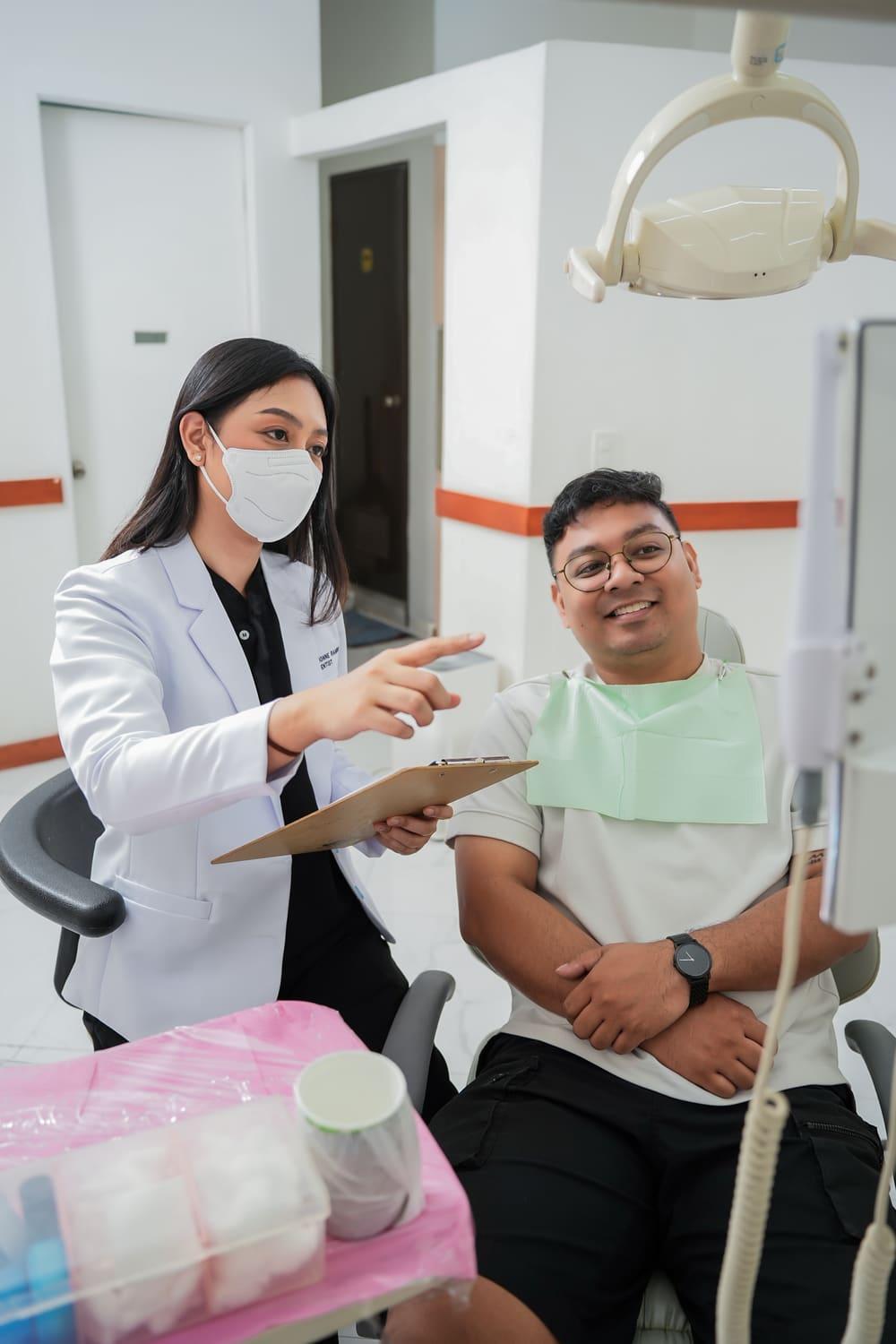 Dentist explaining a treatment plan to a smiling patient